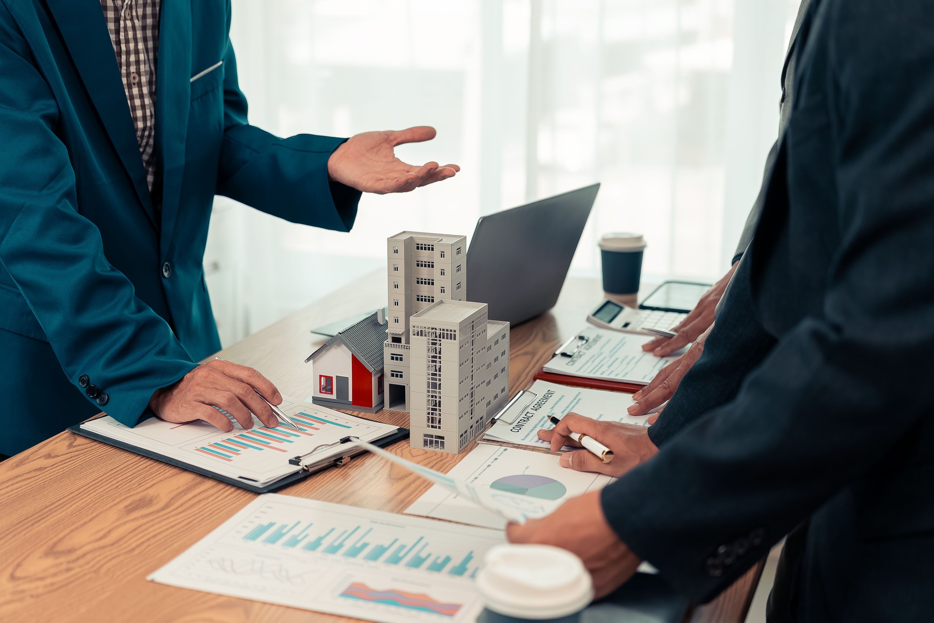 Real estate developers, architects and business teams working on a new business building project in a conference office highlight investment strategies and real estate decisions for future plans.